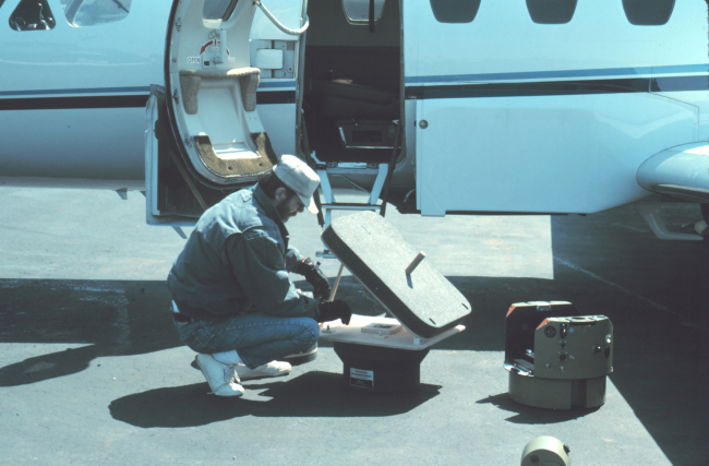 Photogrammetrist Bill Hawken preparing NOAA Cessna Citation II for mission