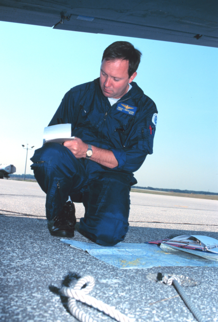 Lieutenant Commander Greg LaMontagne planning aerial photographic mission onRockwell Turbo Commander N53RF