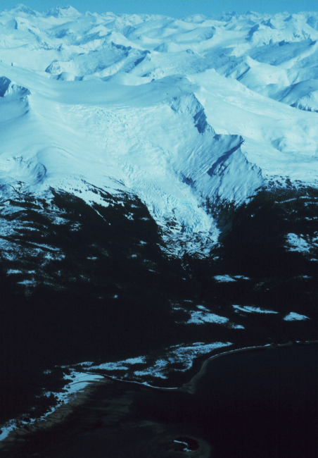 Snow-covered mountains and a retreating glacier to the east of Stephens Passage
