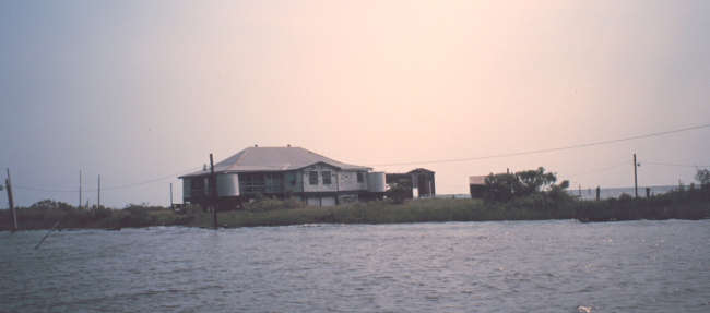 Hunting and fishing camp built on stilts - accessible only by boat althoughpower lines have been run across the marsh