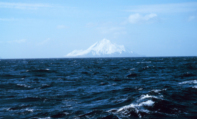 An Aleutian Island peak looms in the distance