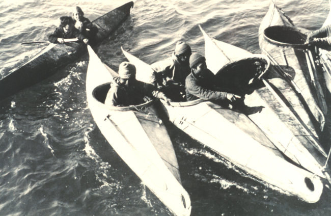 Eskimos congregating in their kayaks