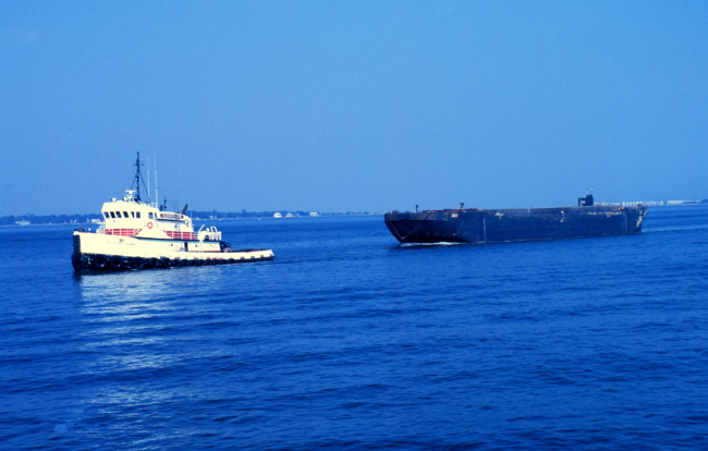 A seagoing tug towing a barge in Charleston Harbor
