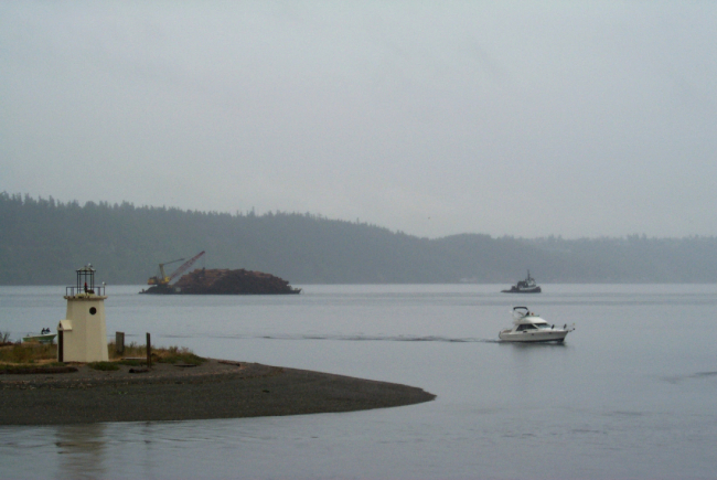 Looking past the spit at Gig Harbor to a barge-load of pine bark headed forto Steilacoom