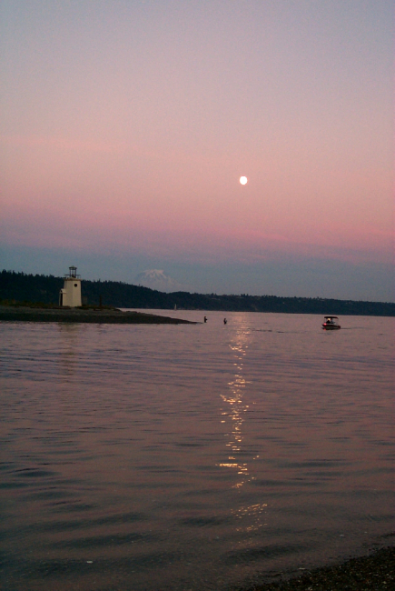 Moonrise over Gig Harbor as salmon fishermen try their luck in the shallows offthe spit