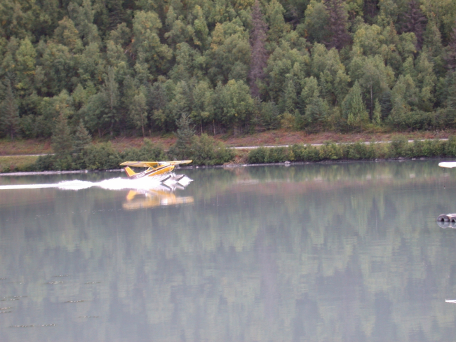 Float plane landing in glacier melt lake