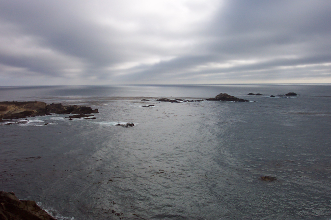 Gray clouds, black rock and a gray sea at Point Lobos State Reserve