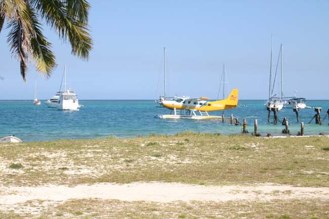 Seaplane taxiing with yachts anchored offshore at Fort Jefferson