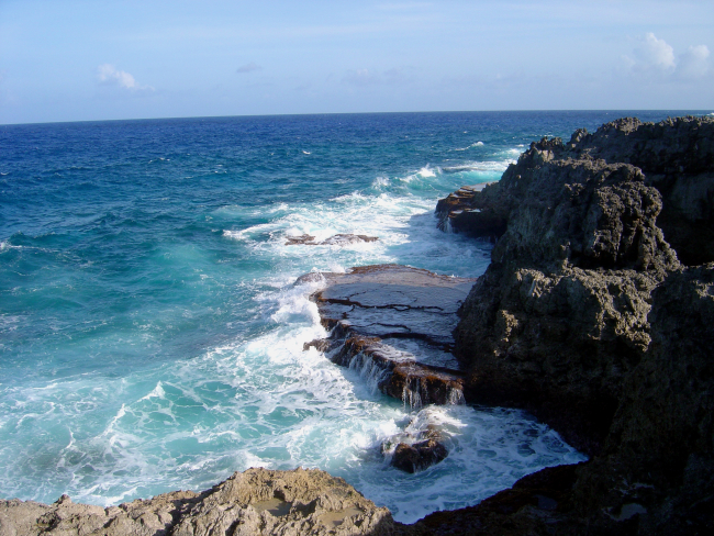Sea, foam, sky, and coral rock meet on the Guam coastline