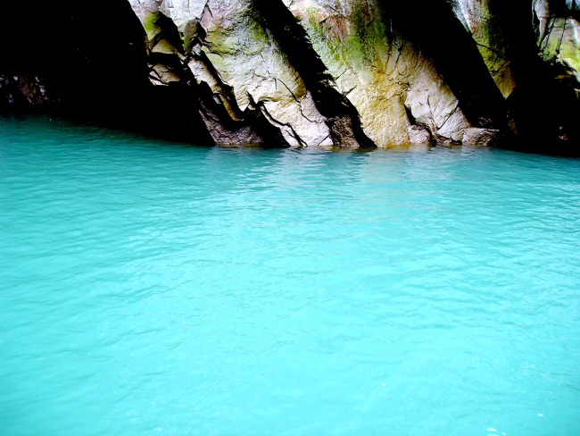Glacial outflow with characteristic aquamarine color where glacial meltwatermerges with the salt water of the fjord