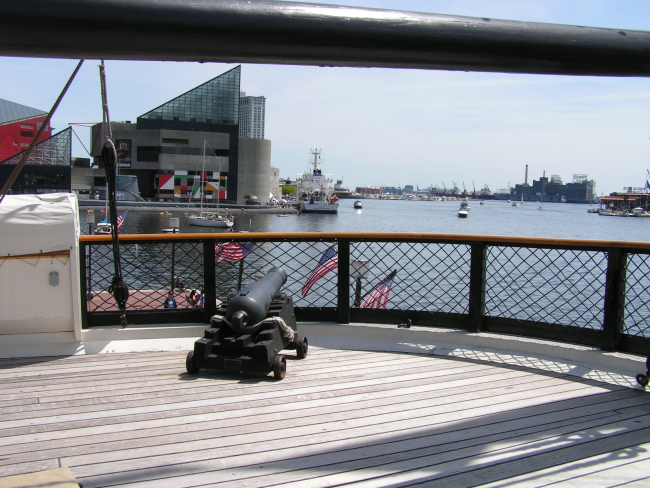 A cannon on the stern of the USS CONSTELLATION pointed at the stern ofthe NOAA Ship THOMAS JEFFERSON in the Inner Harbor