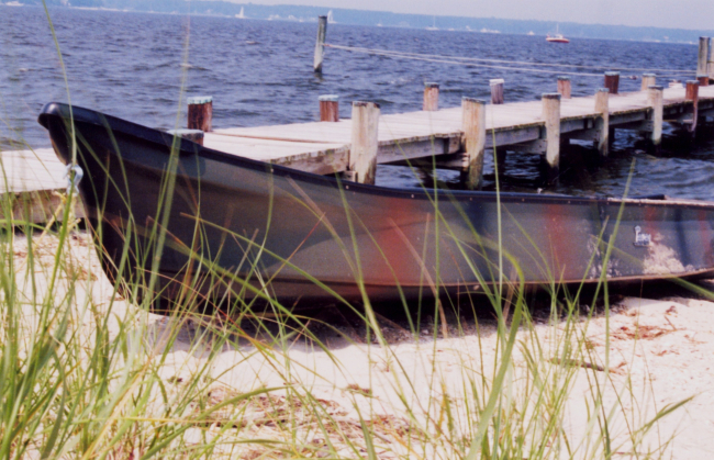 A camouflage-painted hunting skiff along the Patuxent River