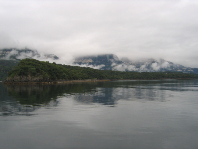 Fog, clouds, mountains, and a still inlet the Alaska Peninsula