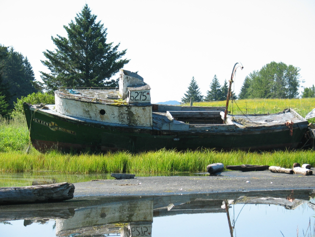 Derelict fishing vessel, the Green Hornet deserted in a quiet Kodiak bay
