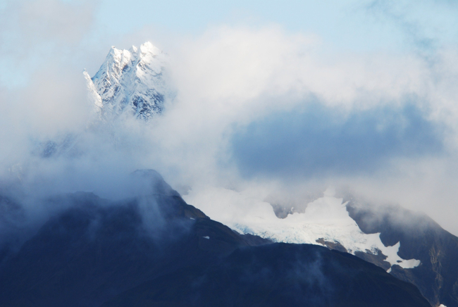 A magnificent mountain peak peeking through the clouds