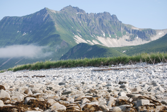 Looking over a boulder beach to rugged mountains of the Alaska Peninsula