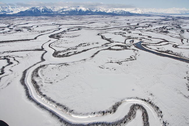 An aerial view of meandering frozen channels of the Copper Riverreminiscent of Nazca Lines