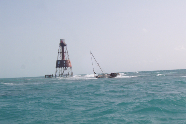 Carysfort Reef Lighthouse with derelict sailboat