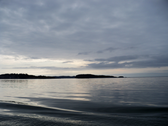 A rare day of glassy smooth waters on the Alaska shoreline