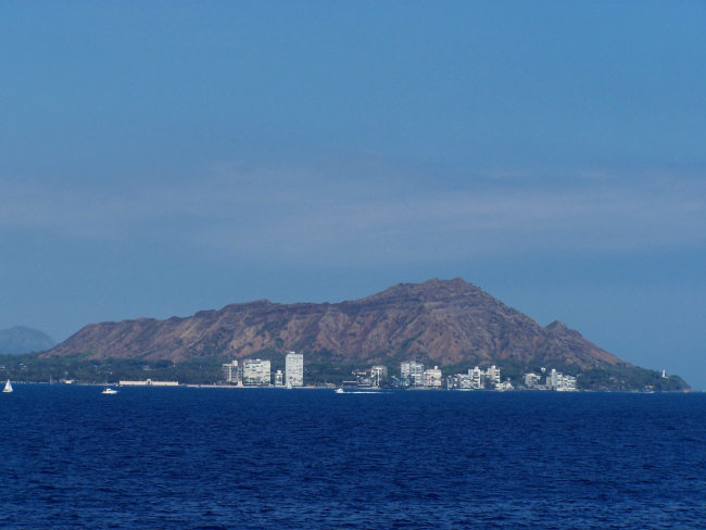 Diamondhead seen from offshore with Diamondhead Light at the right at thebase of the mountain