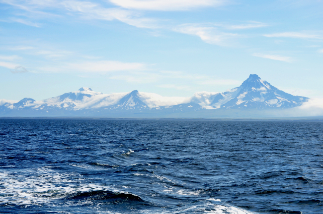 Roundtop is the high mountain on the left, the next is an unnamed peakdesignated Unimak 5270 by the Alaska Volcano Observatory, and Isanotski,locally known as Ragged Jack is on the right