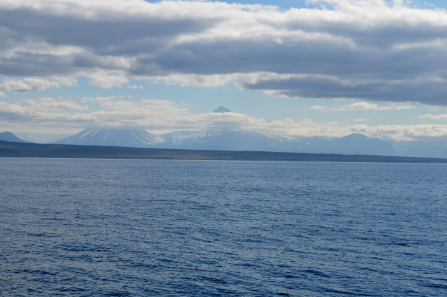 Pavlof Volcano the high peak in the center and Pavlof Sister in center left asseen from the Bering Sea