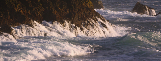 Water running off the rocks following breaking of a wave against the rockyshores of the Big Sur coastline