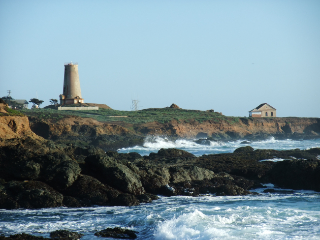 Looking south to the Point Piedras Blancas lighthouse over the shoreline at ahigh tide