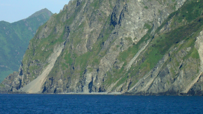 The bold and stunning cliffs of Kodiak Island rising straight out of the sea