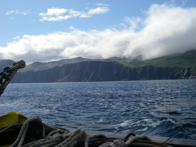 Clouds pouring over an Aleutian island
