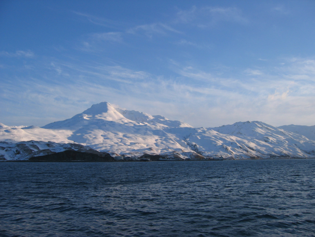 Snow covered mountains running down to the sea at Kodiak