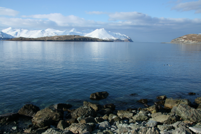 A view of the end of the Dutch Harbor airport runway to the right andvolcanic Aleutian peaks to the left