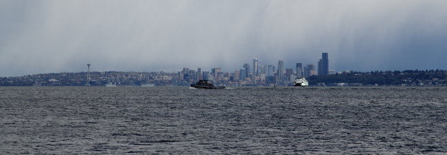 Seattle skyline from Puget Sound with ferryboat and tugboat