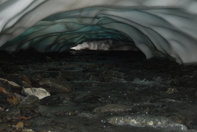 Stream running under a glacier in Seward area