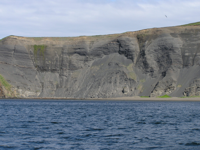 Soft sedimentary rock cliffs, probably volcanic ash, eroding into the sea in theShumagin Islands