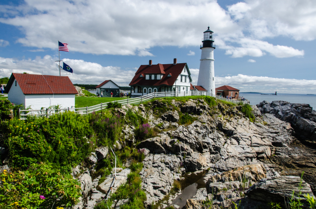 A breezy summer day keeps the flags flying at the Portland Head Lighthouse