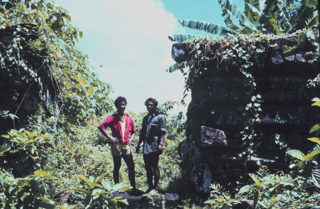 Local guides standing next to basalt buildings of prehistoric Nan Madol