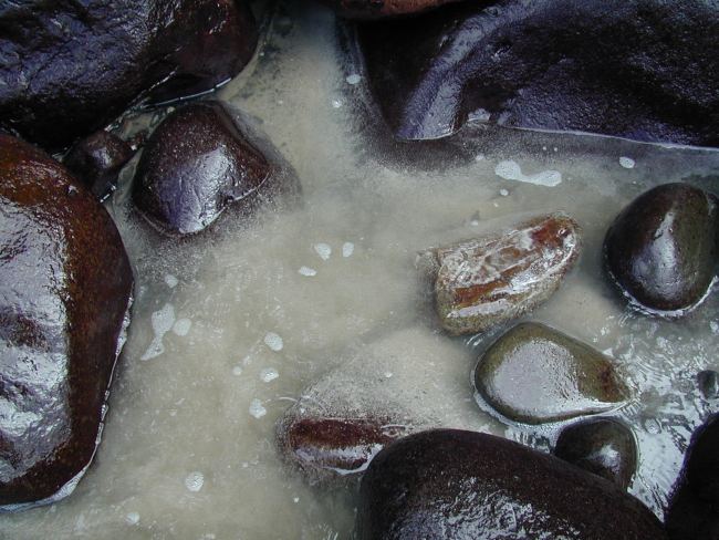 Rocks and sand at a cove on Isla Cocos