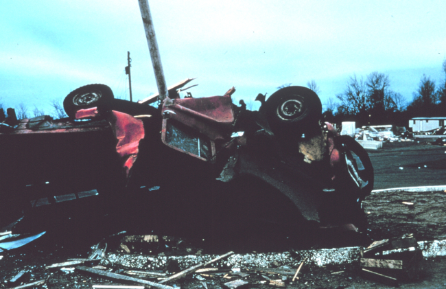 Tornado crushes and rolls farm vehicle, pinning it against a post
