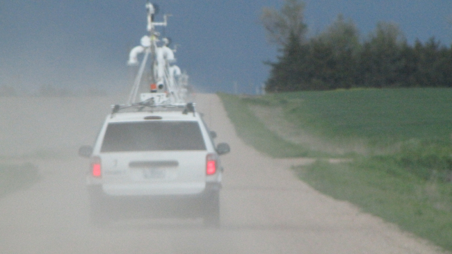 Mobile mesonet vehicles beginning their transects through storms