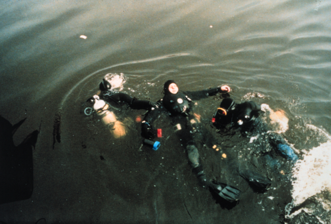 Divers training in handling a disabled dry suit diver