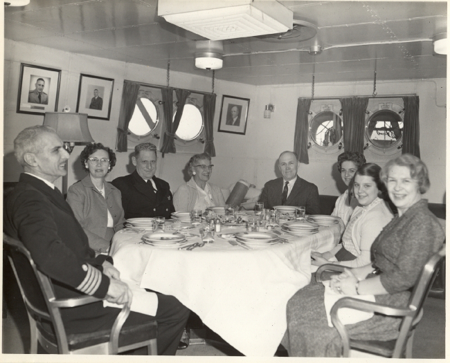 Lunch in the cabin - L to R - Captain Arthur Wardwell, Thelma Whipp, CommanderDavid Whipp, Mrs