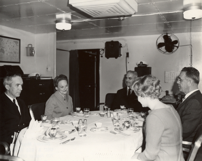 Visitors share lunch in the Captain's cabin