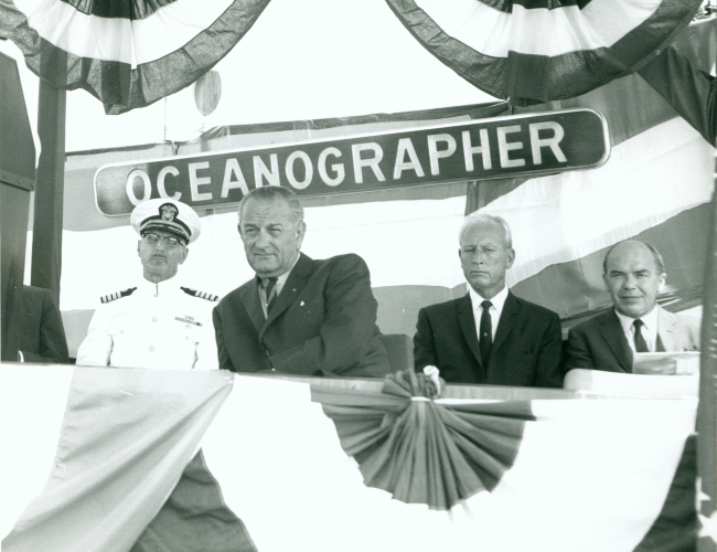 Captain Arthur Wardwell, sitting next to President Johnson at the commissioningceremony of the USC&GS; Ship OCEANOGRAPHER