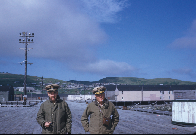 Commander Joseph Partington and Commander Bill Deane of the PIONEER strollingalong the pier at Adak