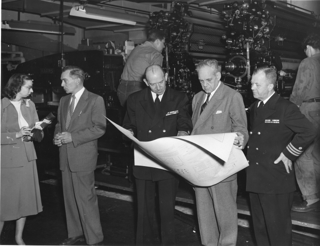 Congressman Campbell of Florida inspecting printed chart with Rear AdmiralRobert Studds and Commander Alvin Thorson