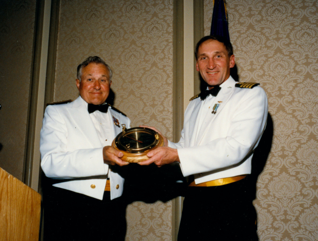 Captain Dick Muller presenting Rear Admiral Eugene Taylor with a mountedbarometer gift