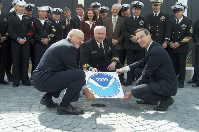 NOAA Administrator VADM Conrad Lautenbacher (R), NOAA Director of NationalMarine Sanctuary Program Dan Basta (L), and Navy Captain Christopher Murray (C), unveil a NOAA Heritage Marker during the grand opening of the USS MonitorCenter at the Mariners' Museum