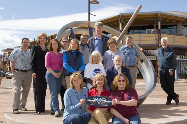 The NOAA Boulder Outreach Coordinating Council and other NOAA personnel shownhere worked with artist and meteorologist Ken Leap to implement a sundialsculpture named Shadows of the Seasons which serves to explain the tilt of the Earth's axis, climate zones, and seasons