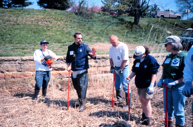 Glenn Page, the Conservation Director for the National Aquarium in Baltimore,instructs volunteers in planting techniques and in using a dibble
